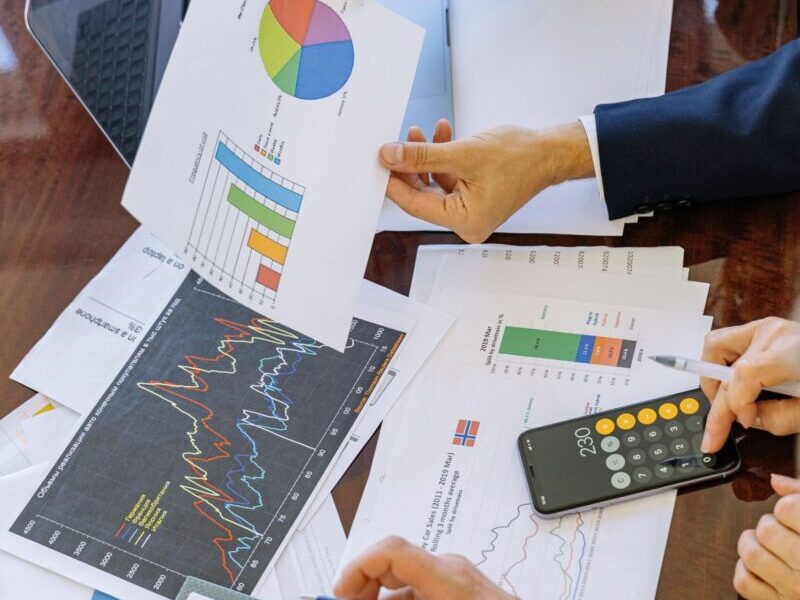 Business professionals analyzing financial charts and graphs during a meeting.